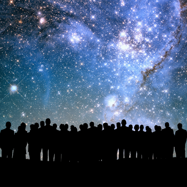 Silhouetted people viewing the milky way